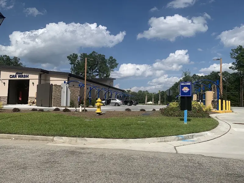 The Zips Car Wash building on Baylor Brook Drive, with its vacuum lanes under a blue sky