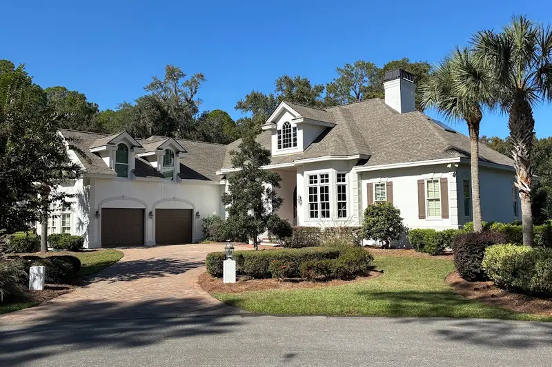 A freshly painted two-story home with a paver driveway in the Bluffton area