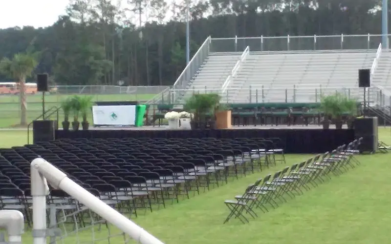 The stadium at Bluffton High School, with chairs set out on the field below the stands