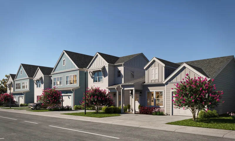 A street of two-story cottages in blue, gray and white with crape myrtles in bloom, as planned for The Bower