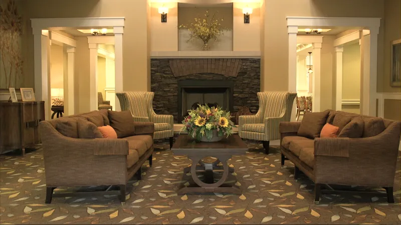 A sitting room with a stone fireplace at The Palmettos of Bluffton