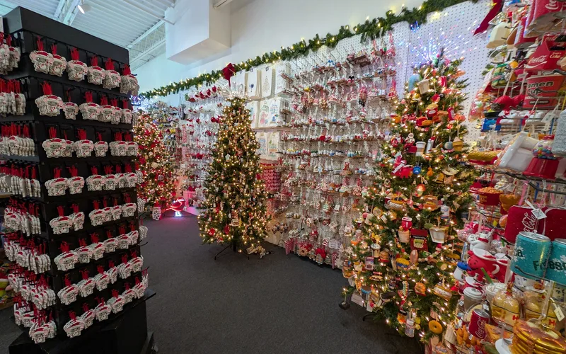 Inside Christmas Mouse at Coligny Plaza: a lit Christmas tree and walls of ornaments in red and white