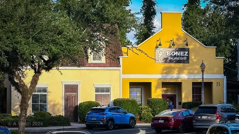 Yellow storefront of Bonez Bar and Grill with its sign on Fording Island Road