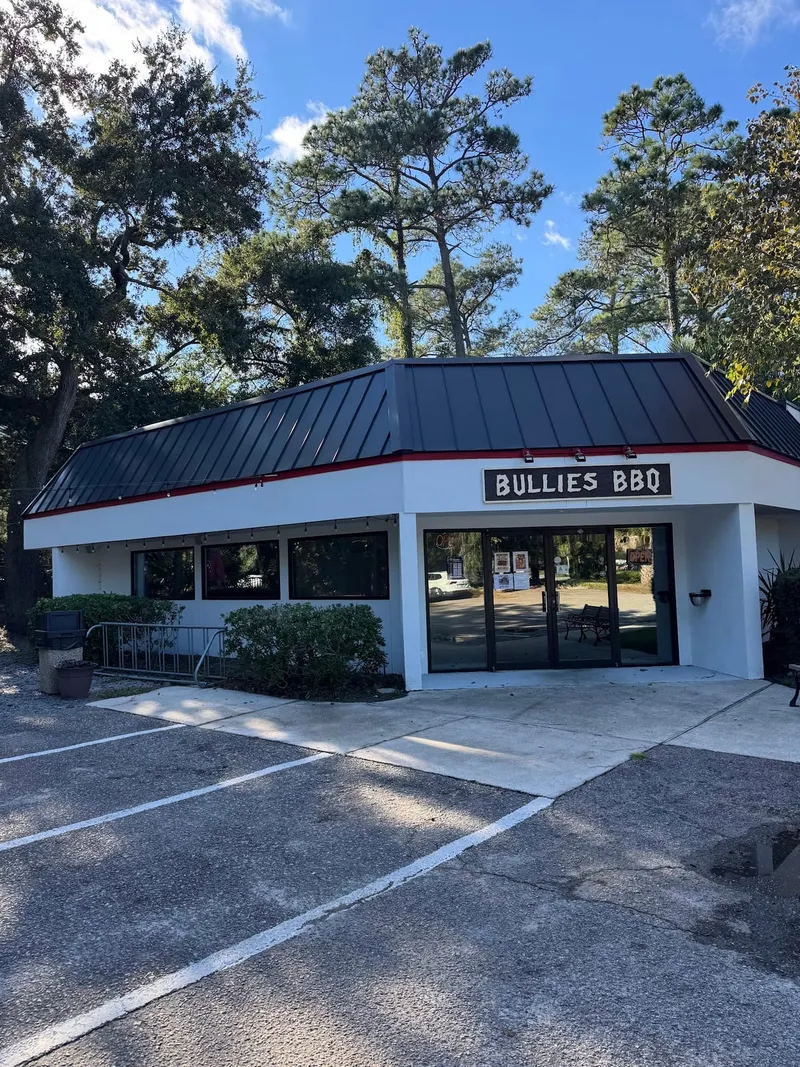 The Bullies BBQ building on Regency Parkway, with its Bullies BBQ sign over the entrance