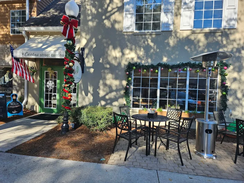 The storefront of Cactus Street Cantina on Main Street with a patio table and heater beside the entrance