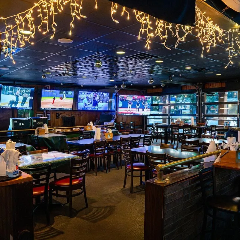 Dining room at Callahan's Irish Sports Pub with tables facing a wall of TVs