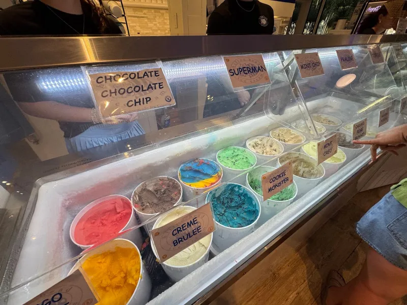 The dipping case at Hilton Head Ice Cream, with tubs of chocolate chocolate chip, creme brulee and bright blue and red flavors