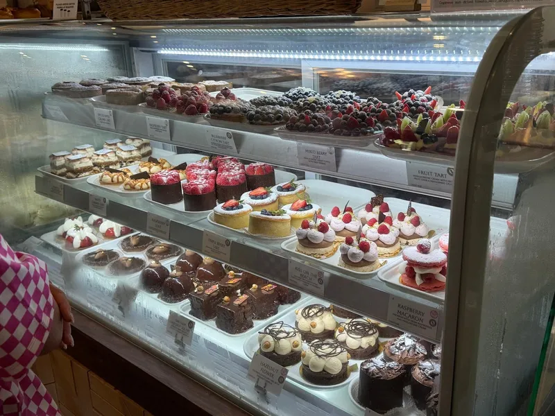The pastry case at Hilton Head Social Bakery, with rows of tarts, mousse cakes and small cakes