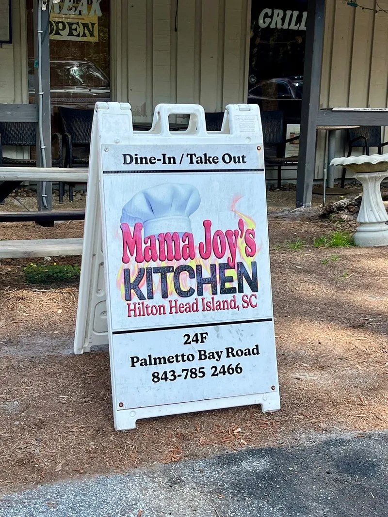 A-frame sign reading Mama Joy's Kitchen, Dine-In / Take Out, 24F Palmetto Bay Road, in front of the restaurant