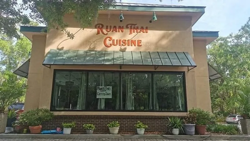 The Ruan Thai Cuisine building with its sign above a row of windows and planters