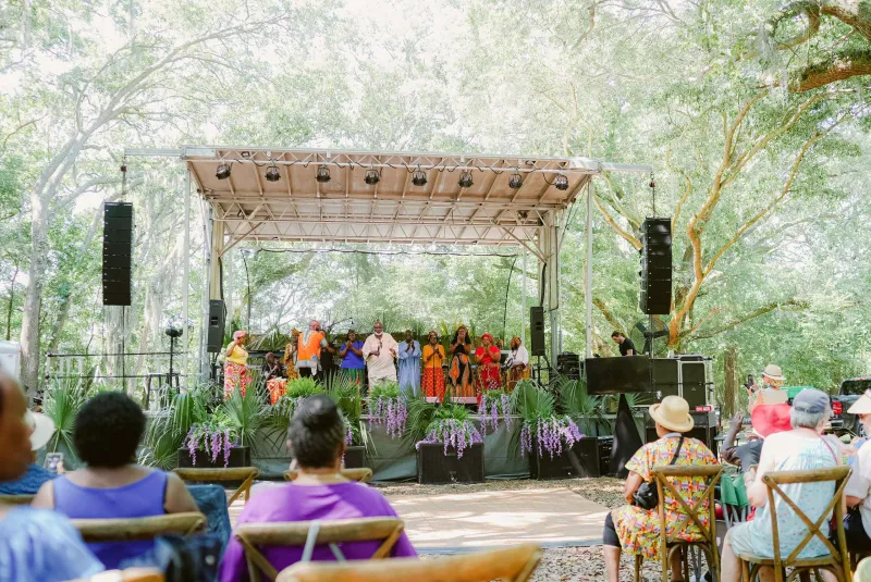 A choir on the stage under the live oaks at the Juneteenth celebration at Historic Mitchelville Freedom Park