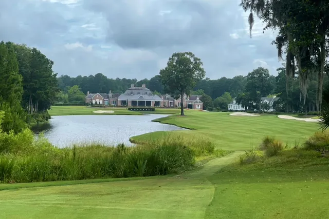 A fairway running past a lagoon toward the Berkeley Hall clubhouse
