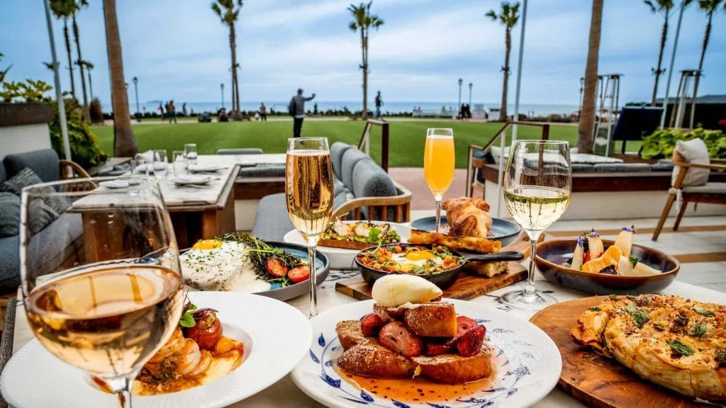 Waterfront table set for brunch with mimosas, overlooking a lawn and the ocean in Hilton Head Island