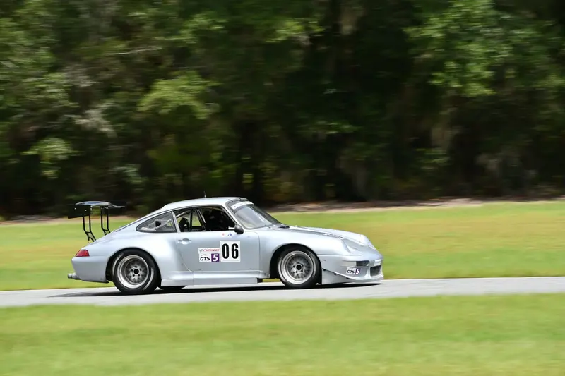 A silver Porsche 911 on track at Roebling Road Raceway during a Porsche Club driver education day