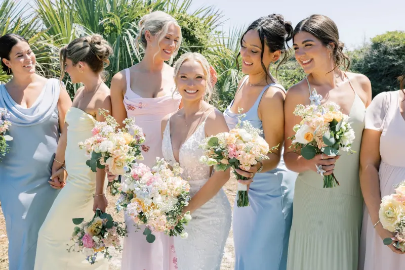Bridesmaids holding white and blush bouquets by Gardenias Floral Design, Hilton Head Island