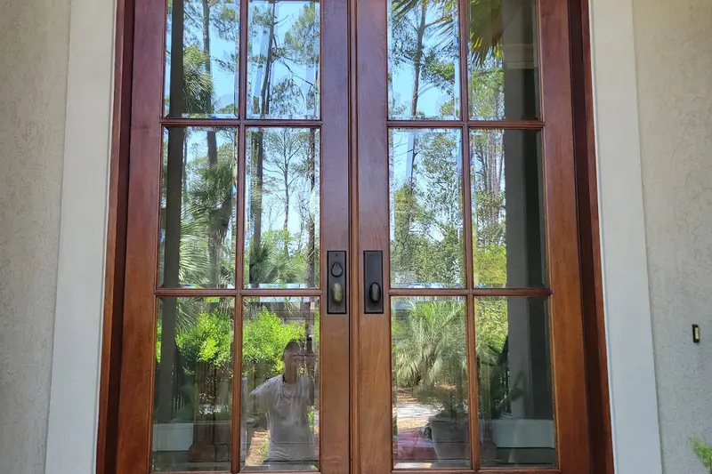 Tall wooden French doors with glass panes on a Hilton Head home