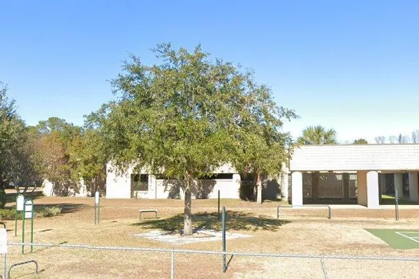 The classroom buildings and fenced playground of the Hilton Head Island School for the Creative Arts on Bus Drive