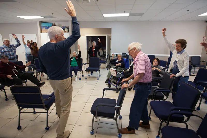 A seated and standing movement class in the Memory Matters program room