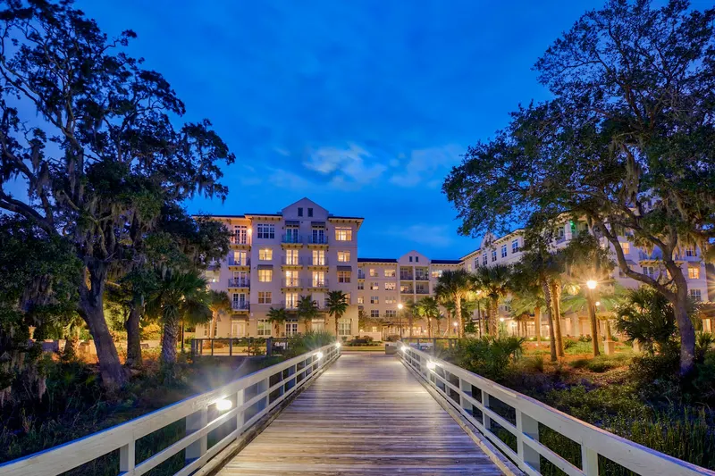 The Bayshore on Hilton Head Island at dusk, seen from its lit boardwalk
