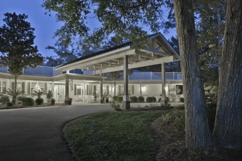The covered entrance of The Pines at Hilton Head at dusk