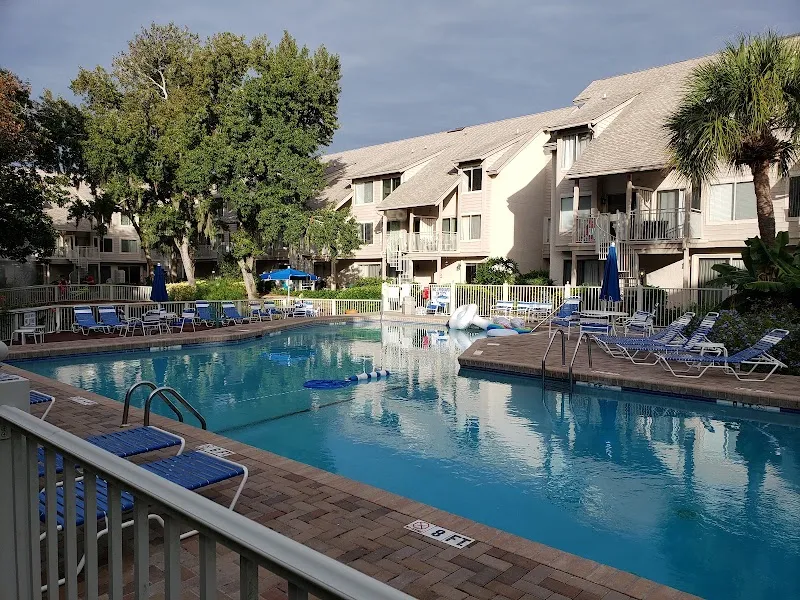 One of the Courtside Villas community pools, with townhouse buildings behind it, South Forest Beach, Hilton Head Island