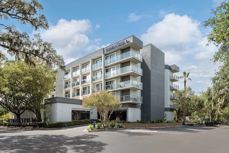 The five-story DoubleTree by Hilton Hilton Head Island seen from the drive under live oaks
