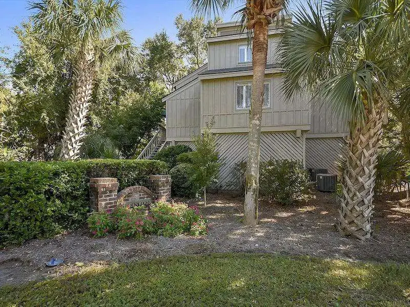 An Oceanwood villa set among palms and shrubs in North Forest Beach, Hilton Head Island