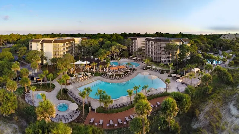 Aerial view of the Omni Hilton Head Oceanfront Resort and its pools, with the ocean beyond