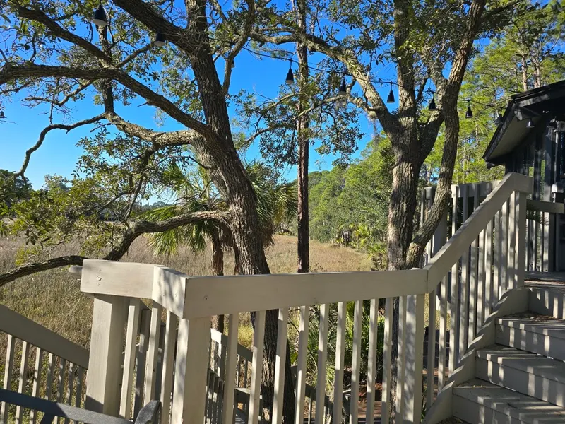 Wooden deck stairs among the oak trees at a Sea Loft villa, Sea Pines