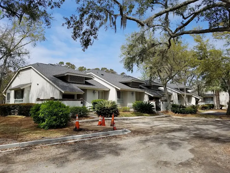A row of Abbington villa buildings under live oaks at Palmetto Dunes