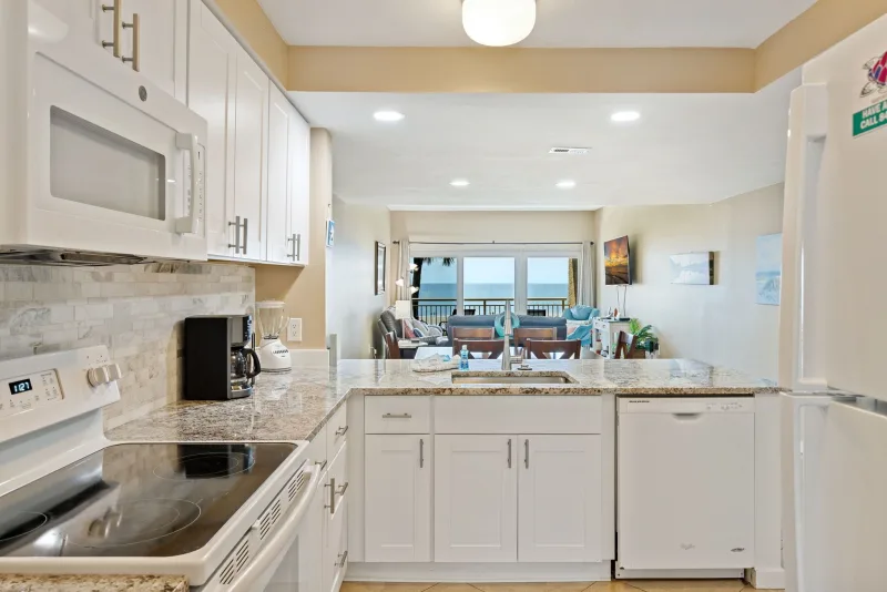 Kitchen opening to the ocean-view living room in a Captain’s Walk villa