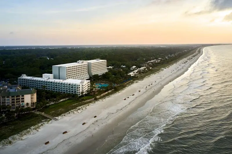 Aerial view of the Hilton Beachfront Resort & Spa, two hotel towers on the beach at Palmetto Dunes