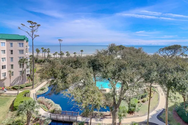 Aerial view of the pool and beach by Windsor Place 302