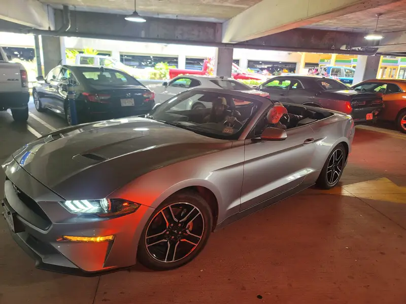 A silver Mustang rental in the covered garage at the Savannah airport