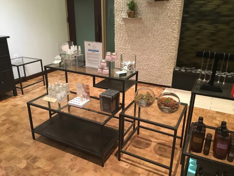 The reception and retail area at Heavenly Spa, with a white pebble wall and a stone water feature