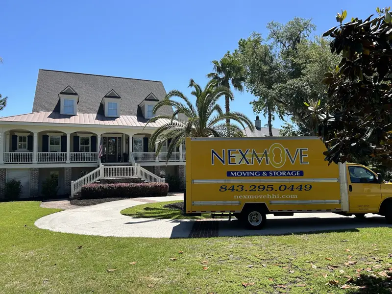 A Nex Move truck parked in front of a Lowcountry home with palms