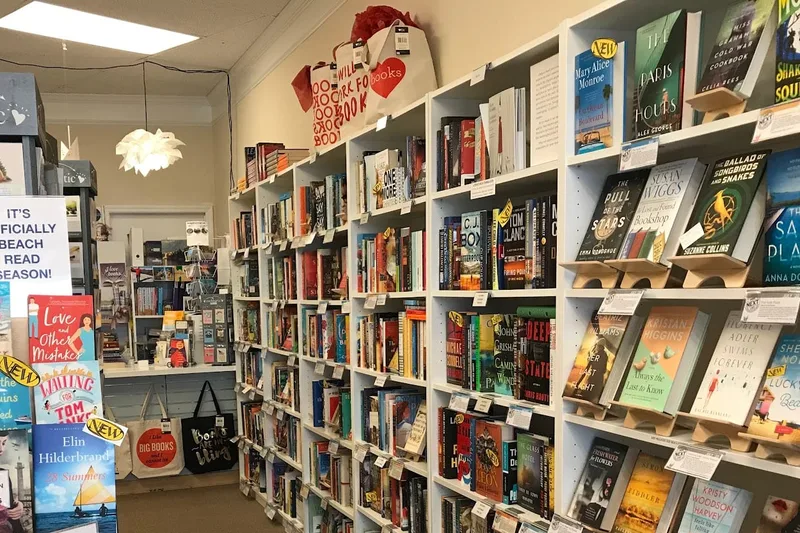 Book-lined shelves and a beach-reads display inside By Hand, Ink at the Shops at Sea Pines Center