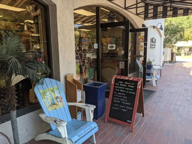 A shop storefront at Harbour Town, Sea Pines, with an Adirondack chair and a sidewalk sign for the General Store
