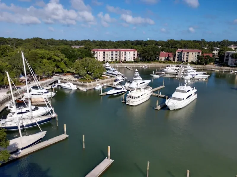 An aerial view of the Harbour Town Yacht Basin with boats docked below the Harbour Town Yacht Club's suites