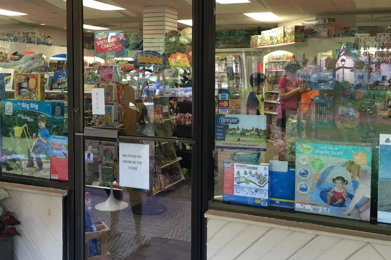 The Hilton Head Toys shop window in Harbour Town, stacked with boxed toys, games and beach gear