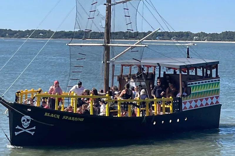 The pirate ship Black Sparrow under way on Calibogue Sound with a full deck of passengers