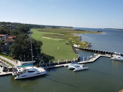 The 18th hole of Harbour Town Golf Links and boats in the Harbour Town marina, seen from the top of the lighthouse
