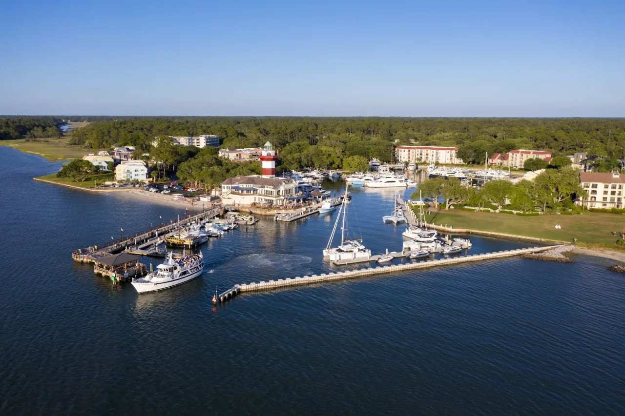 Aerial view of Harbour Town in Sea Pines, with the red-and-white Harbour Town Lighthouse, the marina and Calibogue Sound