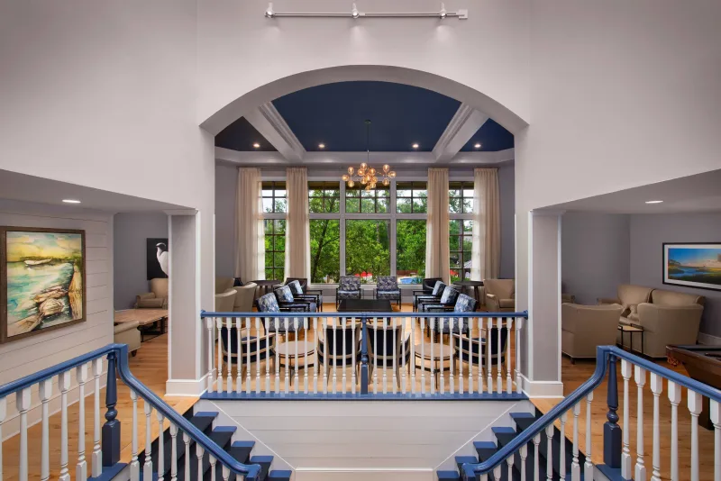 The two-story great room and staircase at Marriott’s Heritage Club, overlooking the pool