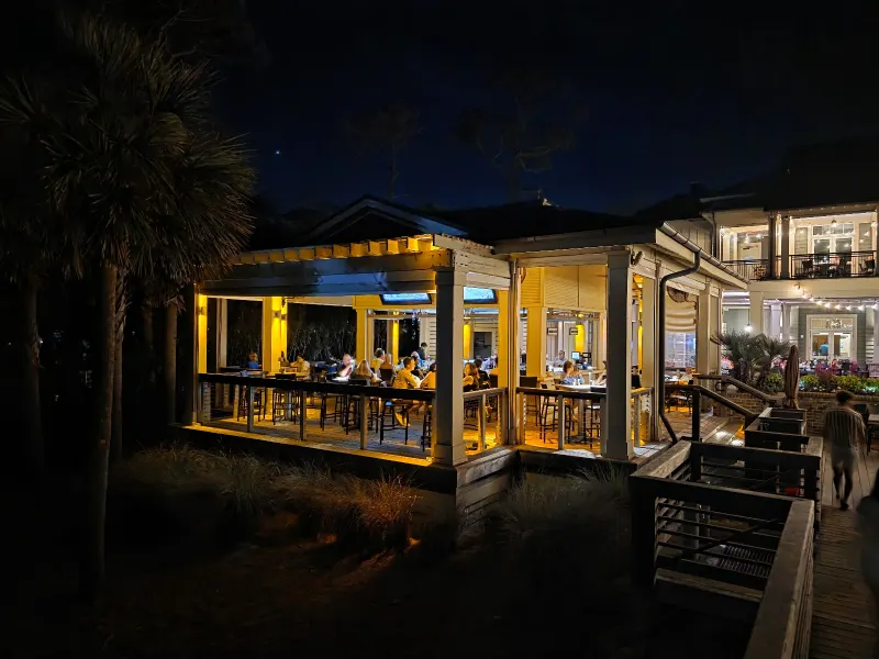 The Sea Pines Beach Club’s open-air bar pavilion lit up at night