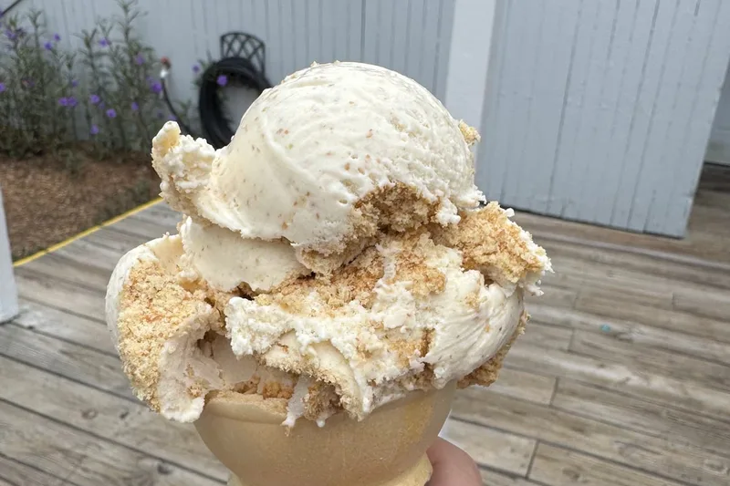 A loaded waffle cone held on the boardwalk outside the Salty Dog Ice Cream Shop at South Beach Marina