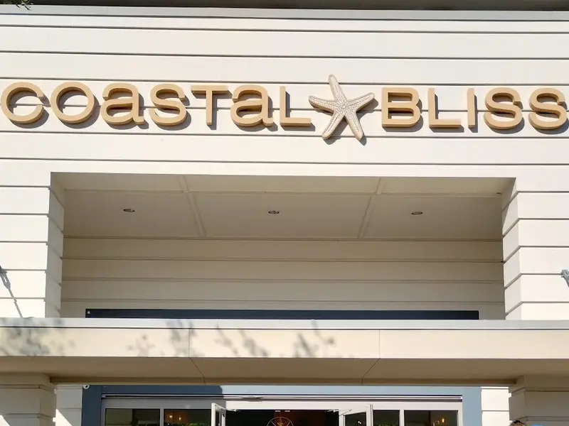 The Coastal Bliss sign, with a starfish between the words, above the boutique’s entrance at Shelter Cove