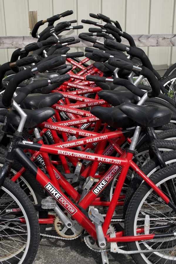 Rows of red rental bikes at The Bike Doctor