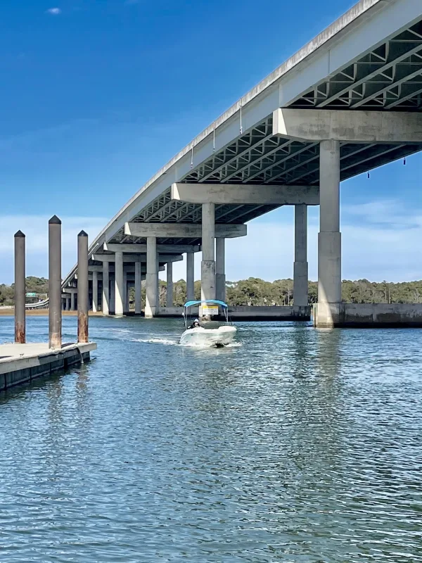 A rental boat passing under the bridge near Hilton Head Boat Rentals