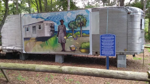 A mural of a Gullah woman and a cottage on the grounds of the Gullah Museum of Hilton Head Island